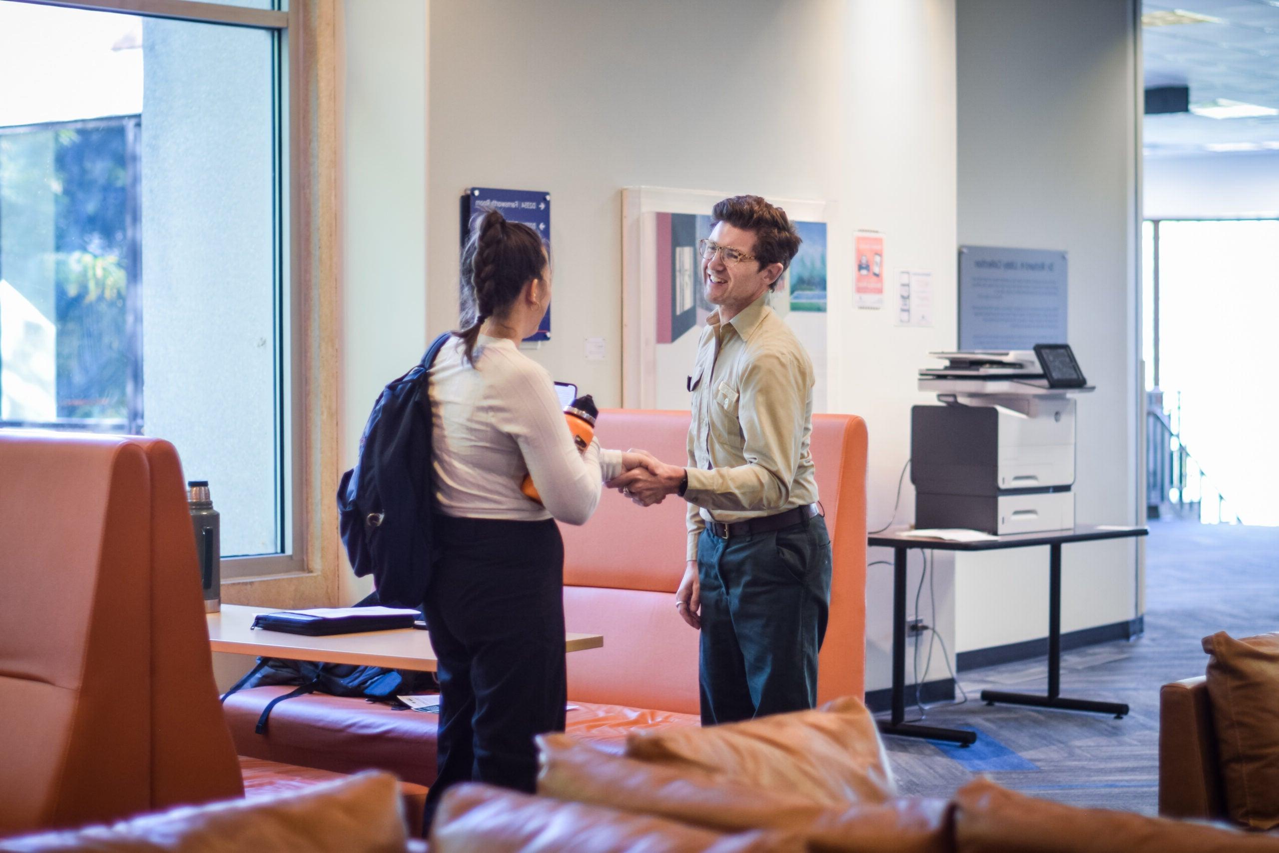 Student shaking hands with an employer in the SUB after having an individual consultation